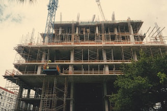 A construction site with workers collaborating on a building project, highlighting teamwork and progress.