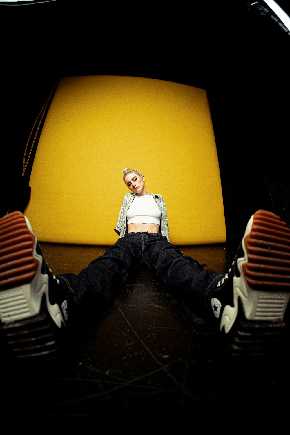 a woman sitting on top of a yellow chair