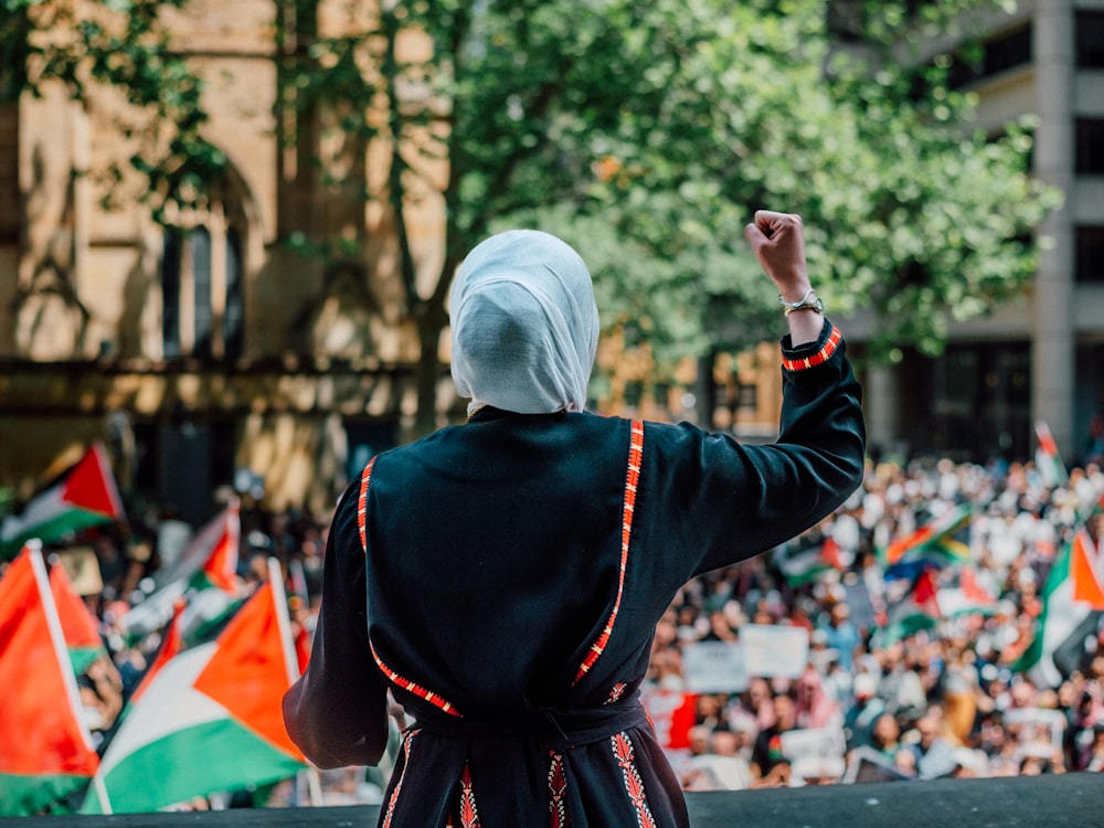 a woman in a black robe and a crowd of people