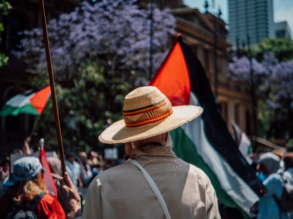 a man with a straw hat holding a flag