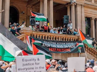 a large group of people holding flags and banners