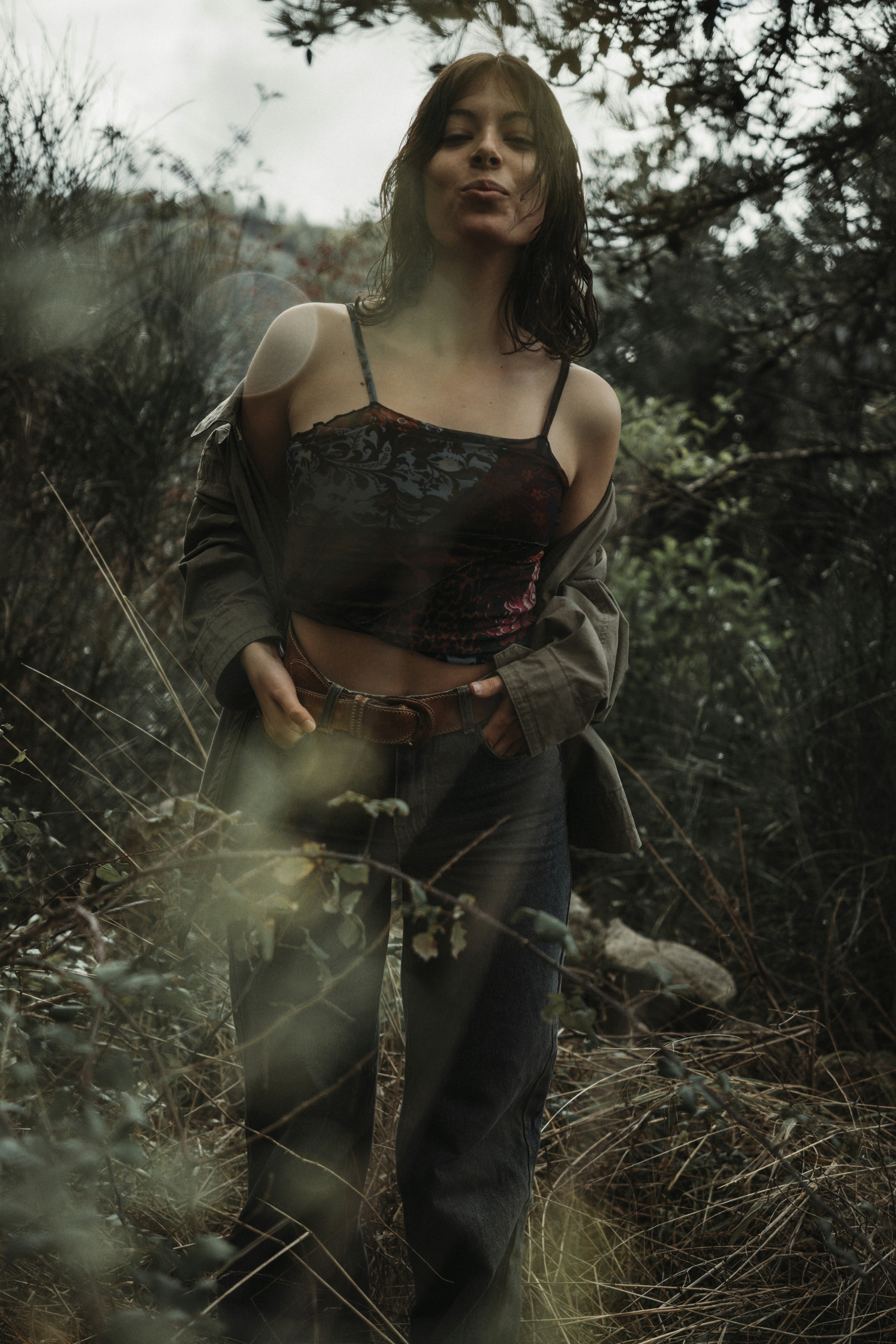 a woman standing in a field of tall grass