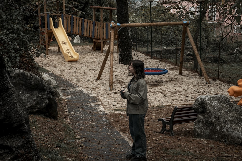 a woman standing in front of a playground