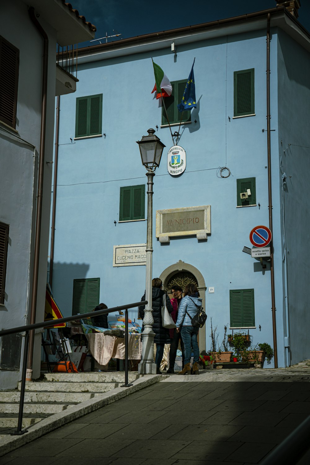 a couple of people that are standing in front of a building