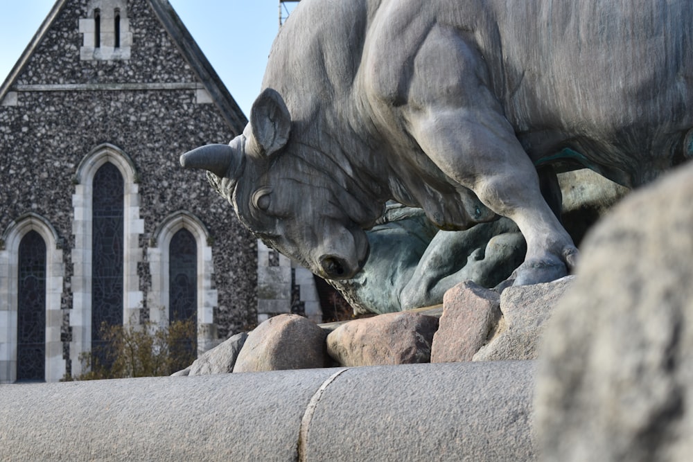 a statue of a bull in front of a church