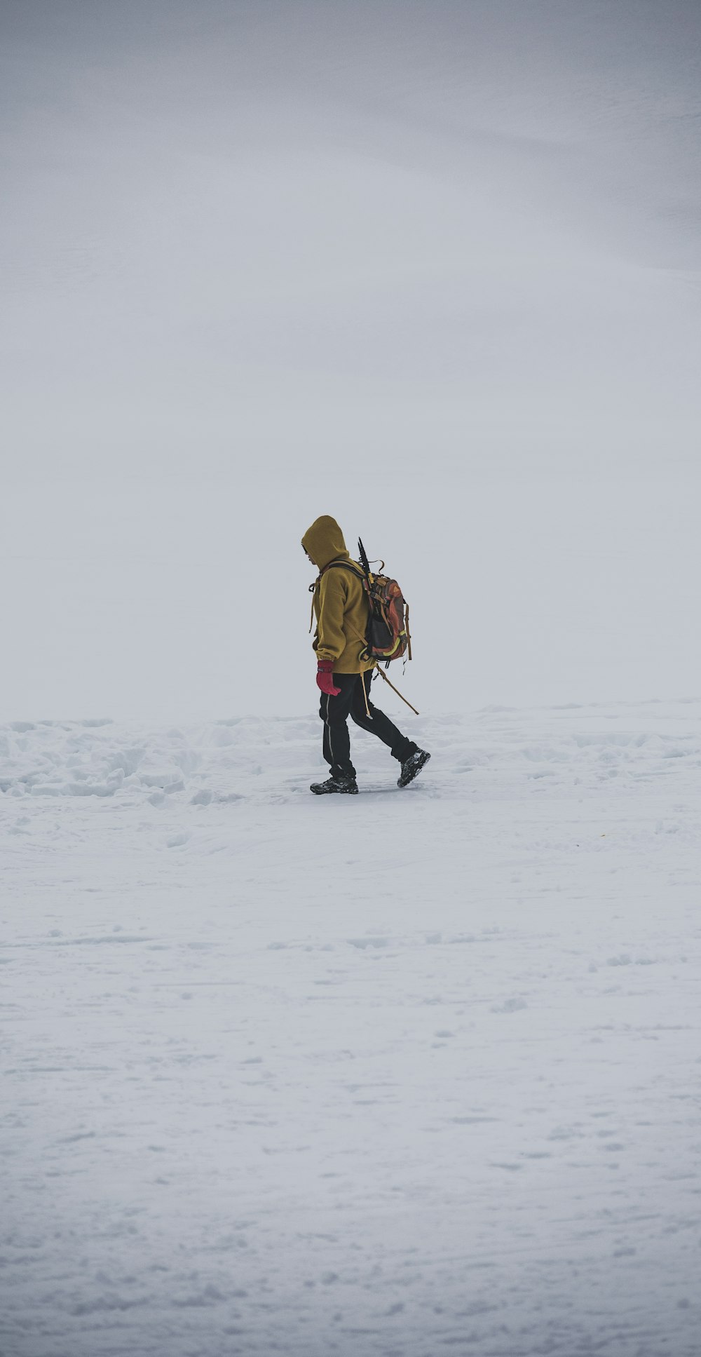 a person walking across a snow covered field