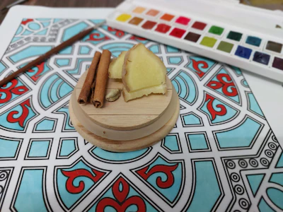 Handcrafted spice packets tied with twine, resting on a wooden table with subtle royal patterns.
