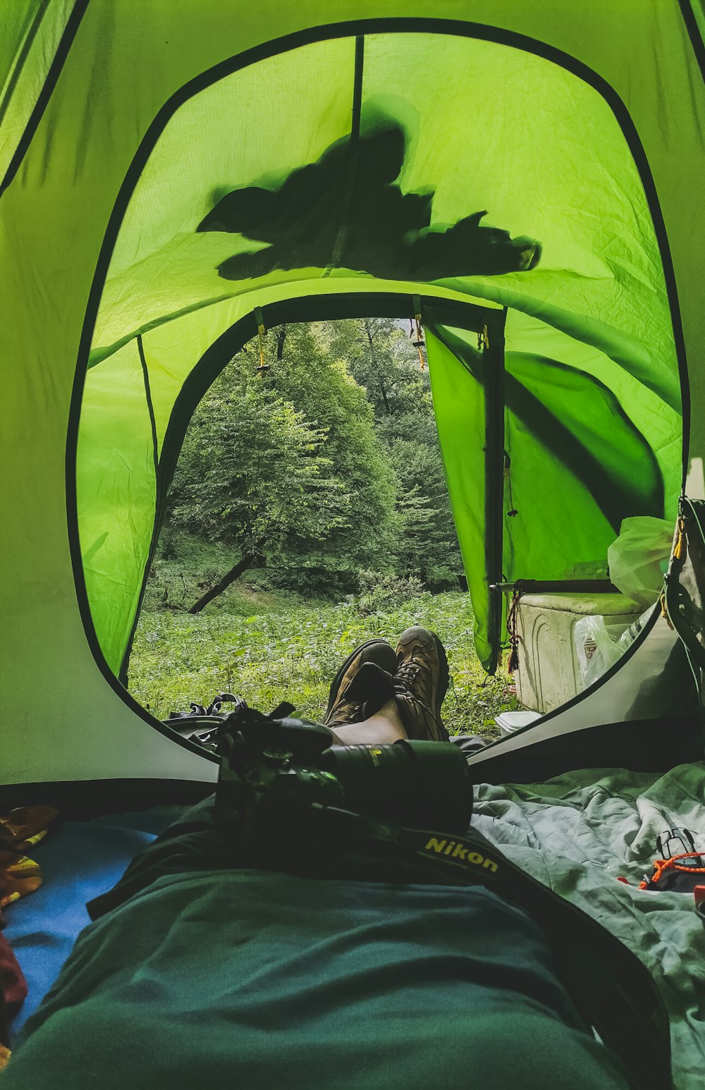 a person laying in a tent with their feet up