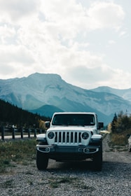 A family SUV parked beside a mountain trail, ready for an adventure.