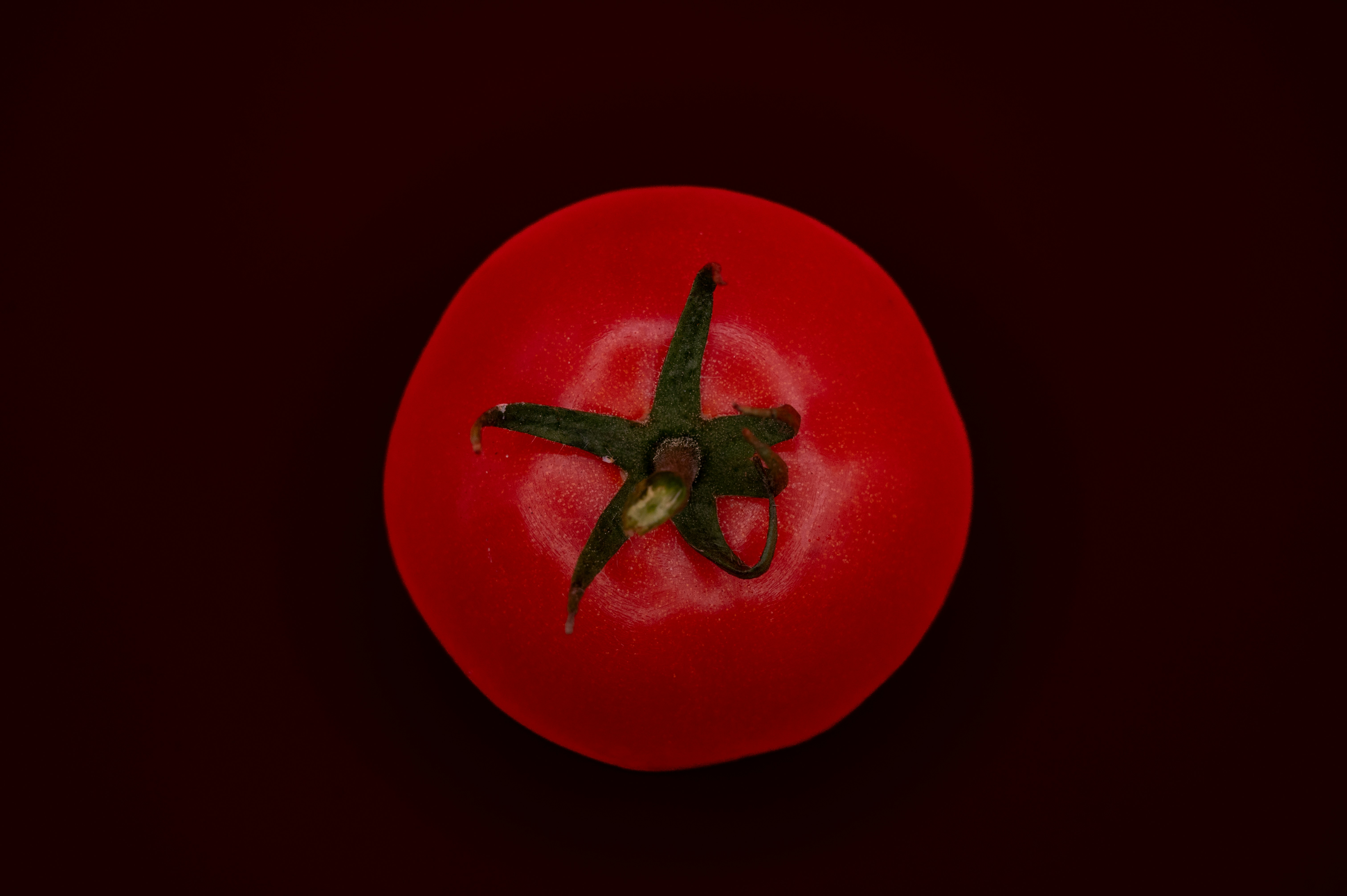 a close up of a tomato on a black background