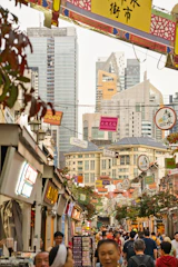 A bustling Hangzhou street with modern buildings and busy trade activity reflecting vibrant commerce.