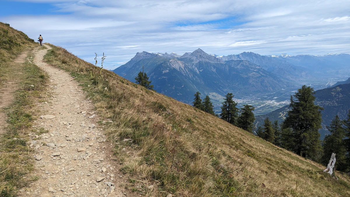 Walker following a mountain trail on the Tour du Mont Blanc