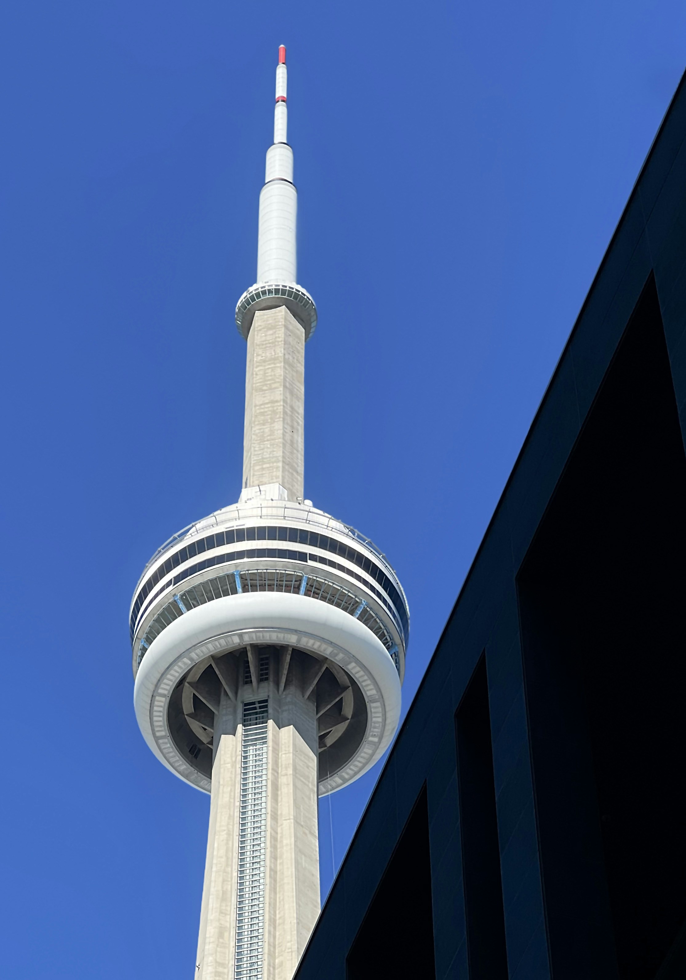 a tall white tower with a red top