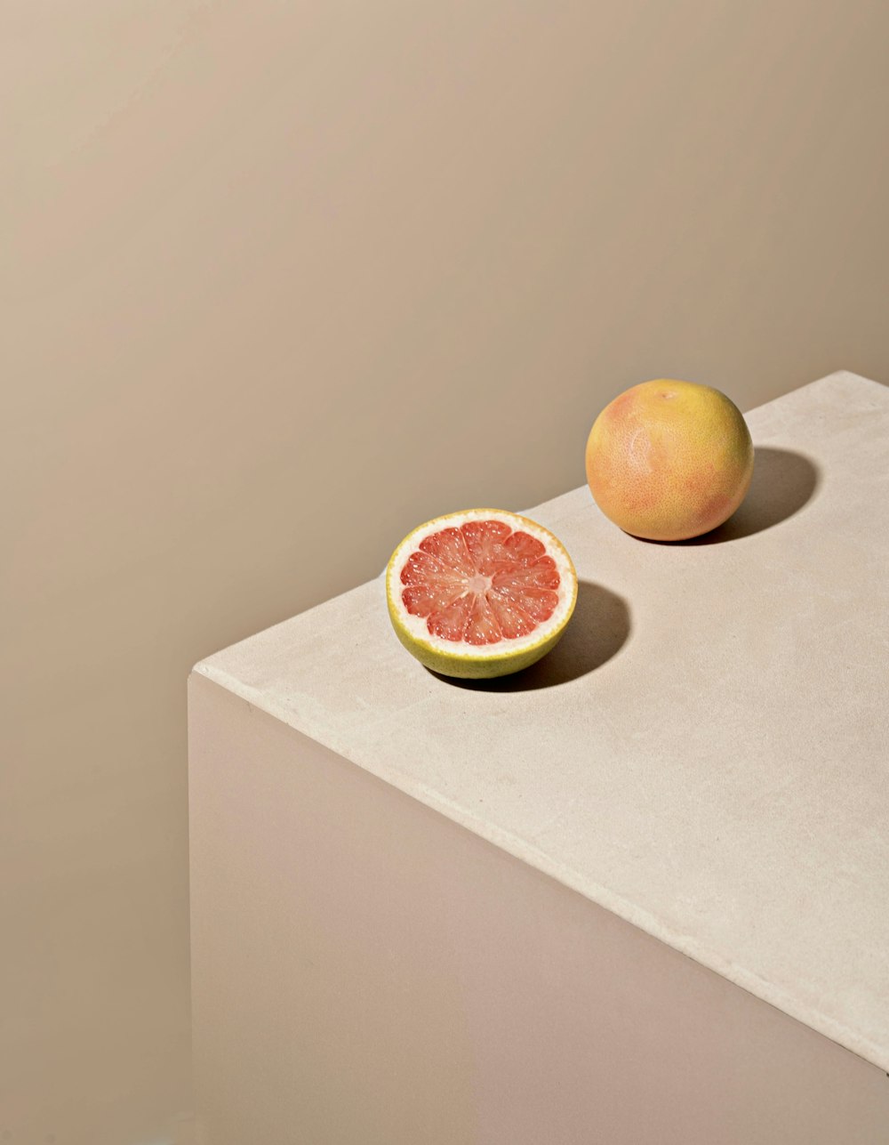 a grapefruit and a grapefruit on a table