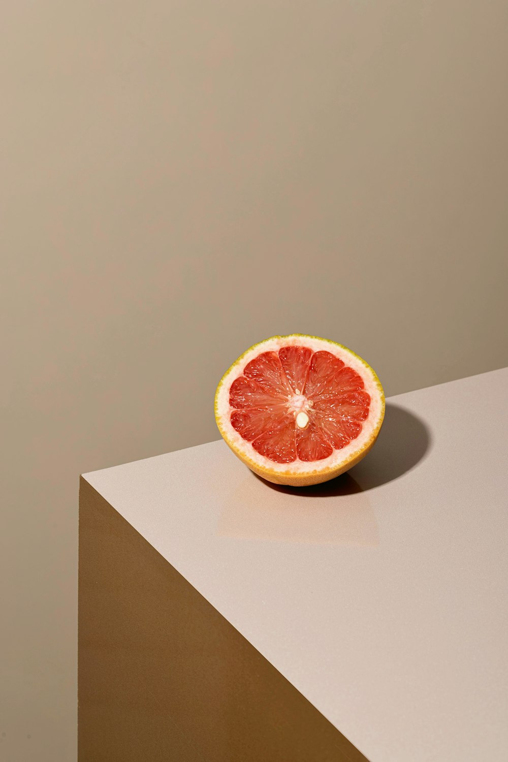 a grapefruit cut in half sitting on a table