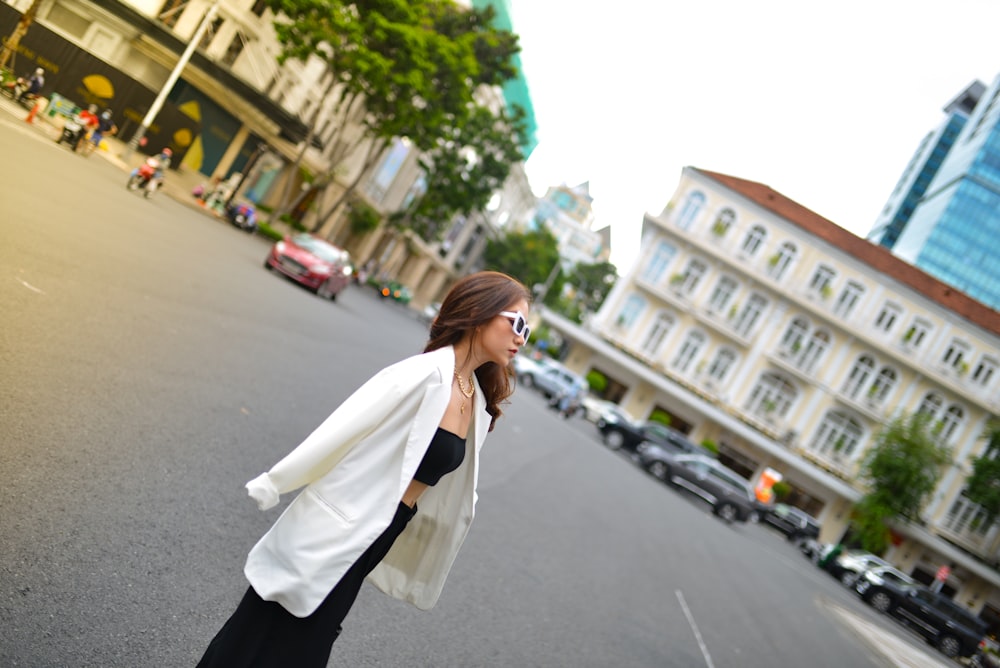 a woman standing in the middle of a street