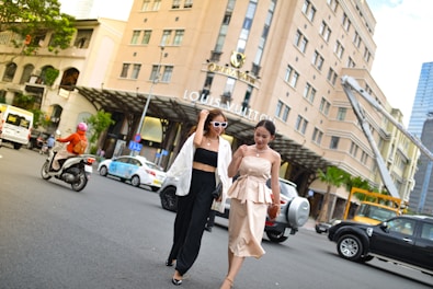 Women walking confidently in stylish urban outfits downtown.