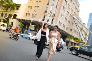 A group of women walking confidently in stylish, comfortable fashion on a sunny city street.