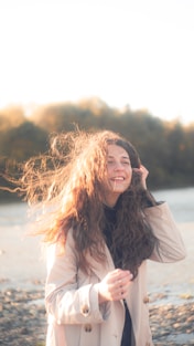 a woman with long hair is talking on a cell phone