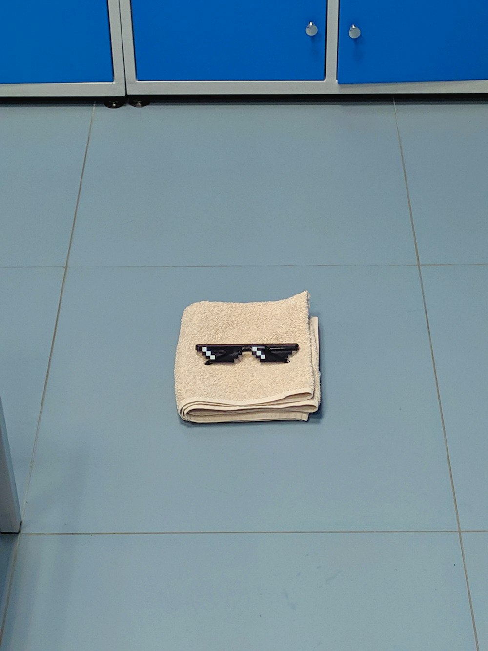 a pair of sunglasses laying on top of a towel