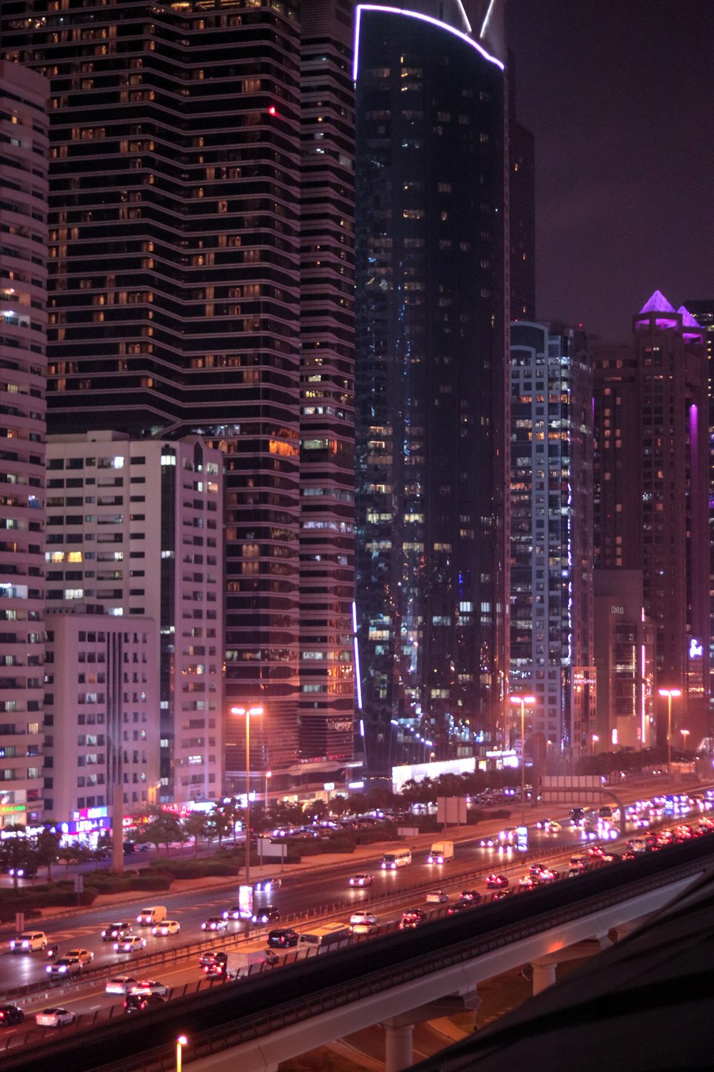 a city at night with lots of tall buildings