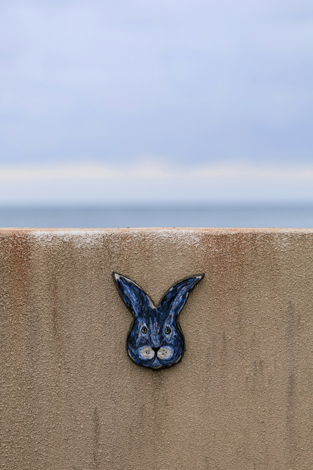 a blue rabbit head on the side of a wall