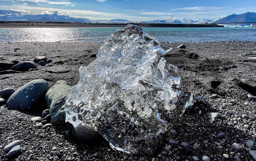 a large piece of ice sitting on top of a beach