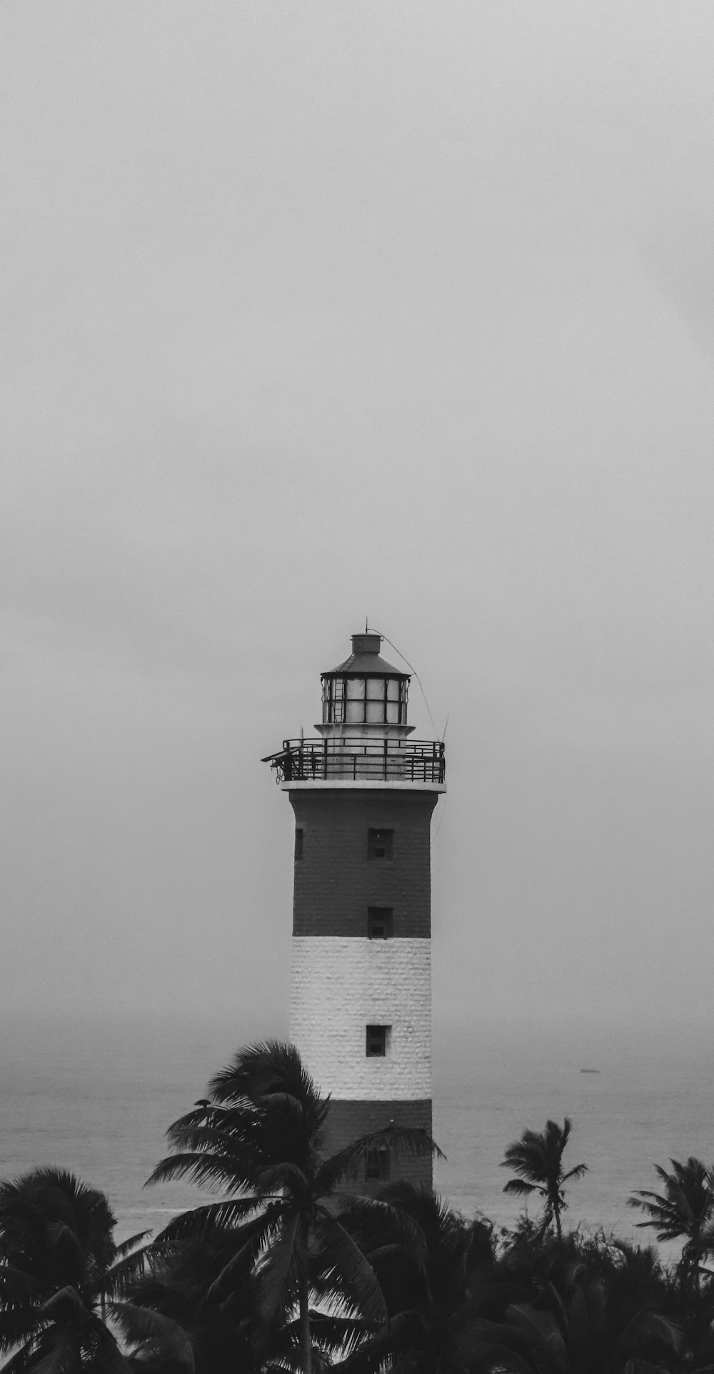 a black and white photo of a lighthouse