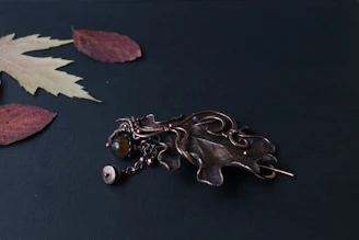 A collection of medieval brooches displayed on aged leather, showing off their antique finishes.