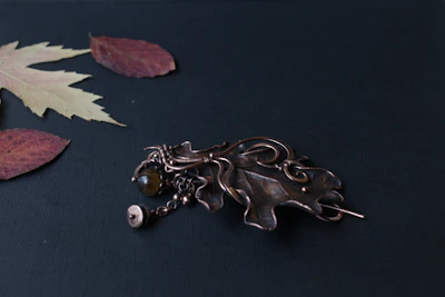 A collection of medieval brooches displayed on aged leather, showing off their antique finishes.