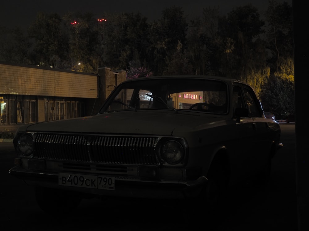 a car parked in a parking lot at night