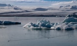 A tranquil glacier lagoon filled with floating icebergs.