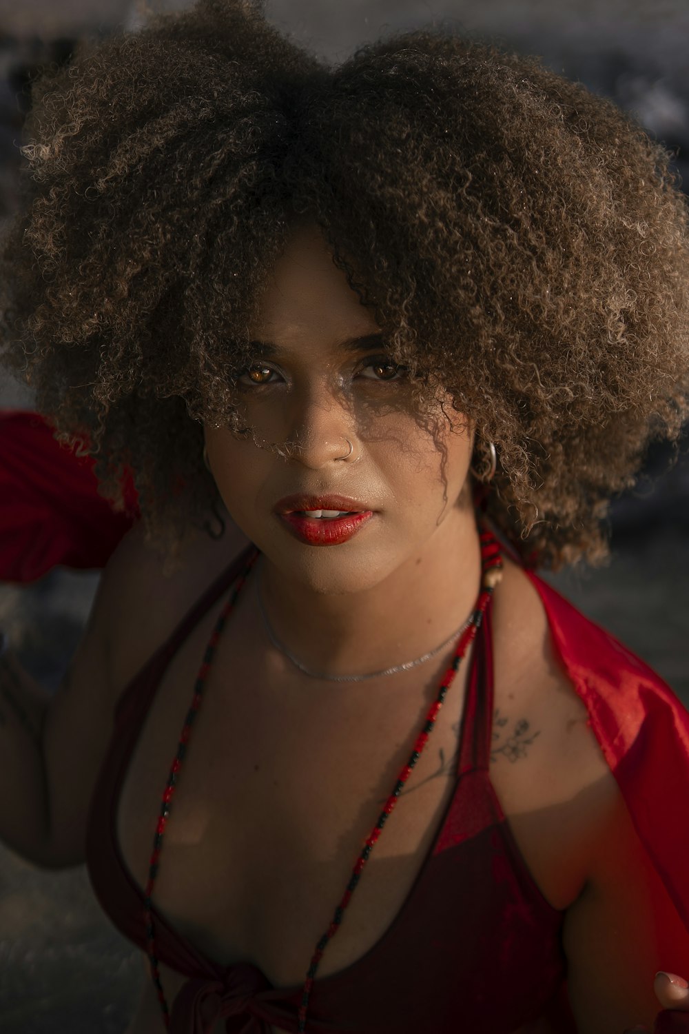 a woman wearing a red dress and a necklace