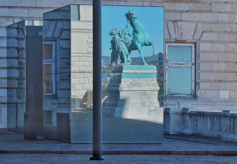 a reflection of a statue of a man on a horse