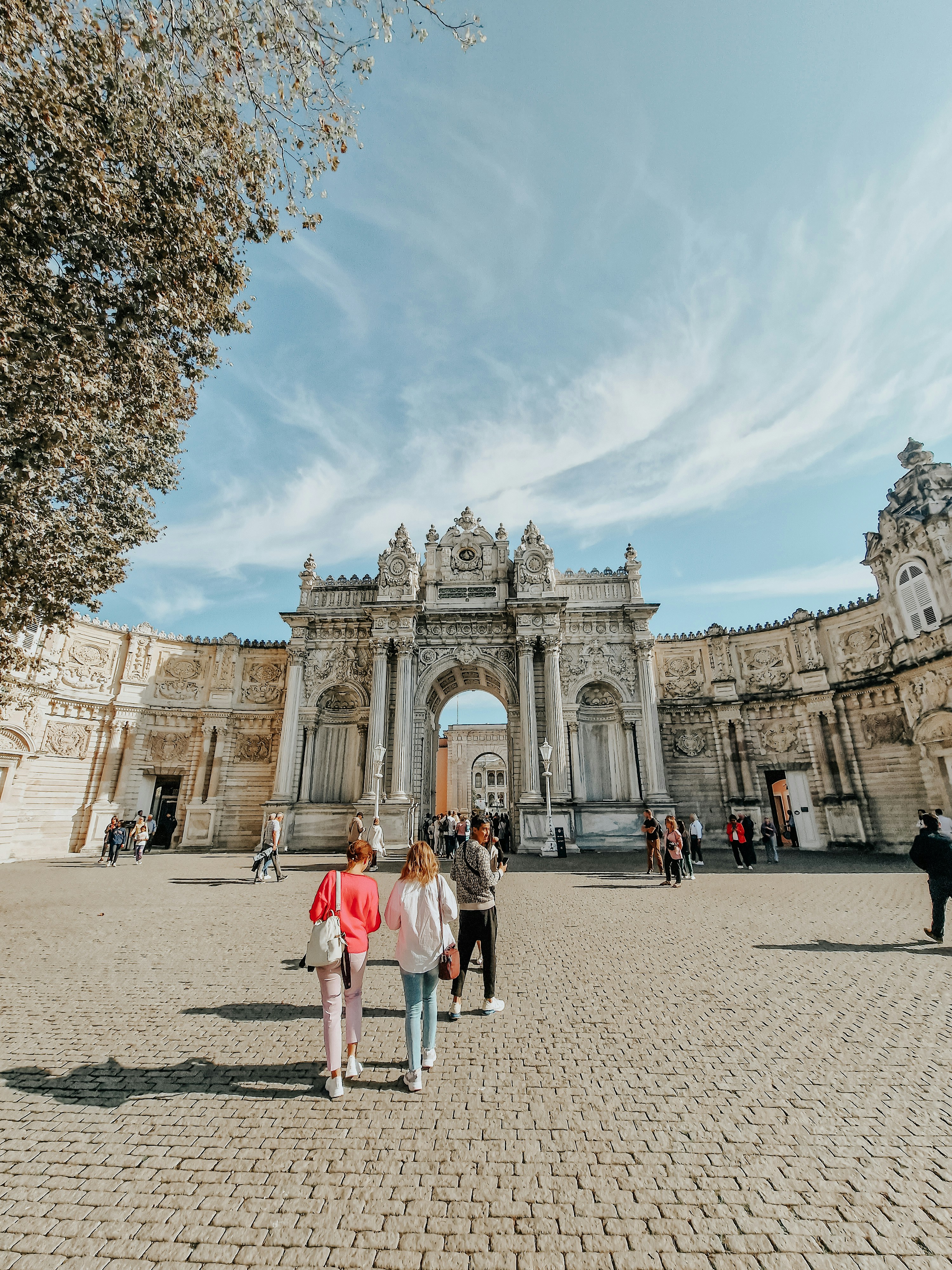 A group of people walking in front of a building photo – Free Building ...
