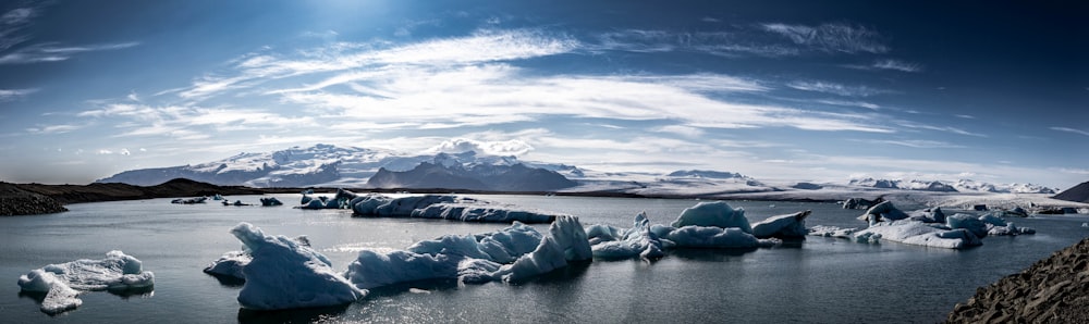 a large body of water surrounded by snow covered mountains