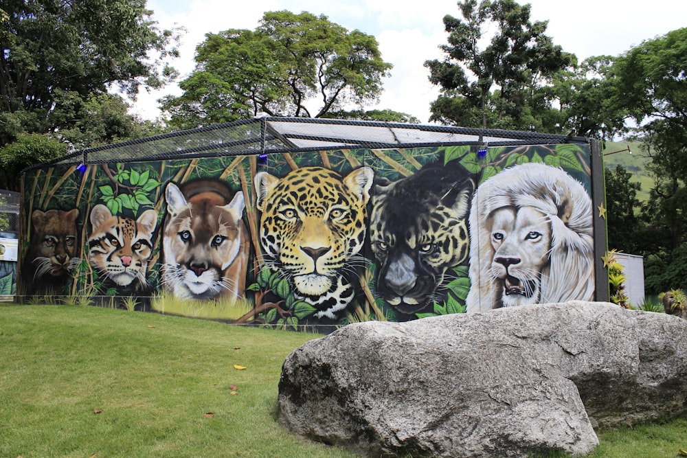 a painting of a group of wild animals on the side of a building