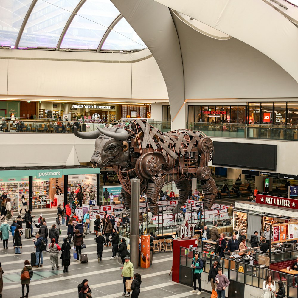 a group of people walking around a shopping mall