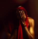 a man covering his face with his hands