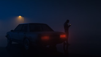 Hands skillfully unlocking a car door at night with a flashlight illuminating the scene.