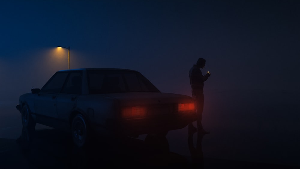 a person standing next to a car in the fog