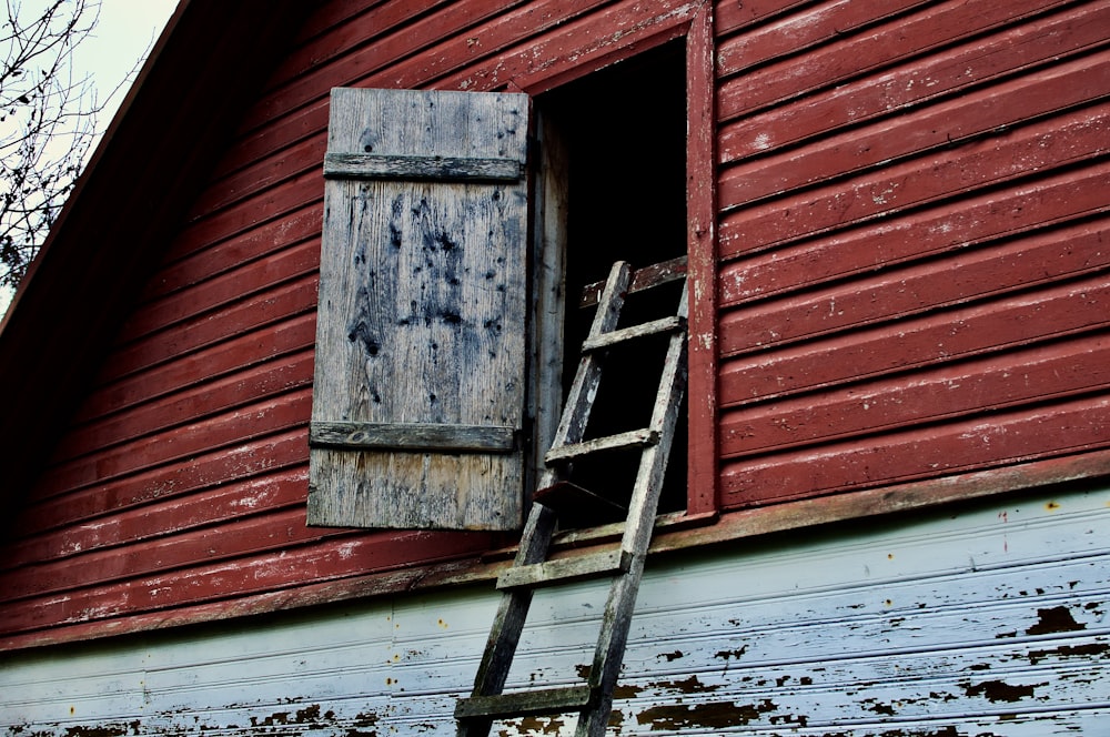 a ladder leaning up against a red barn