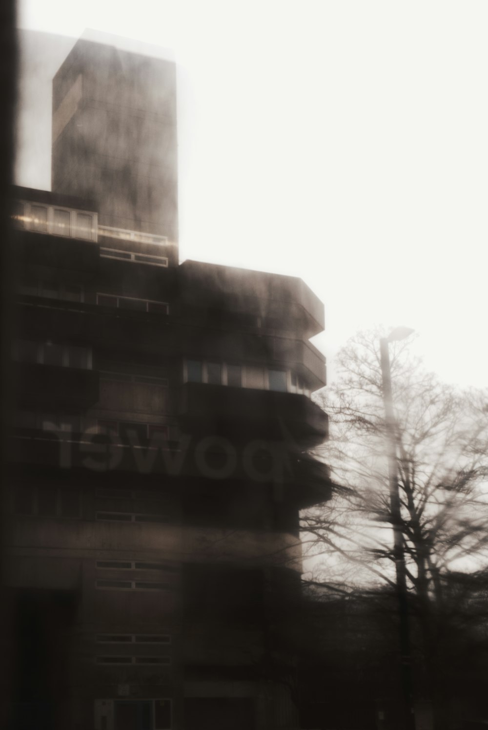 a blurry photo of a building with a street sign in front of it