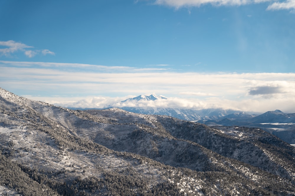 a view of a mountain range with snow on the ground