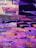 Colorful paper banners with intricate cut-out designs are strung across an outdoor space. The banners, primarily in shades of purple and orange, contrast with the aged stone and brick structure behind them. Windows with bars can be seen in the background, indicating an urban setting.