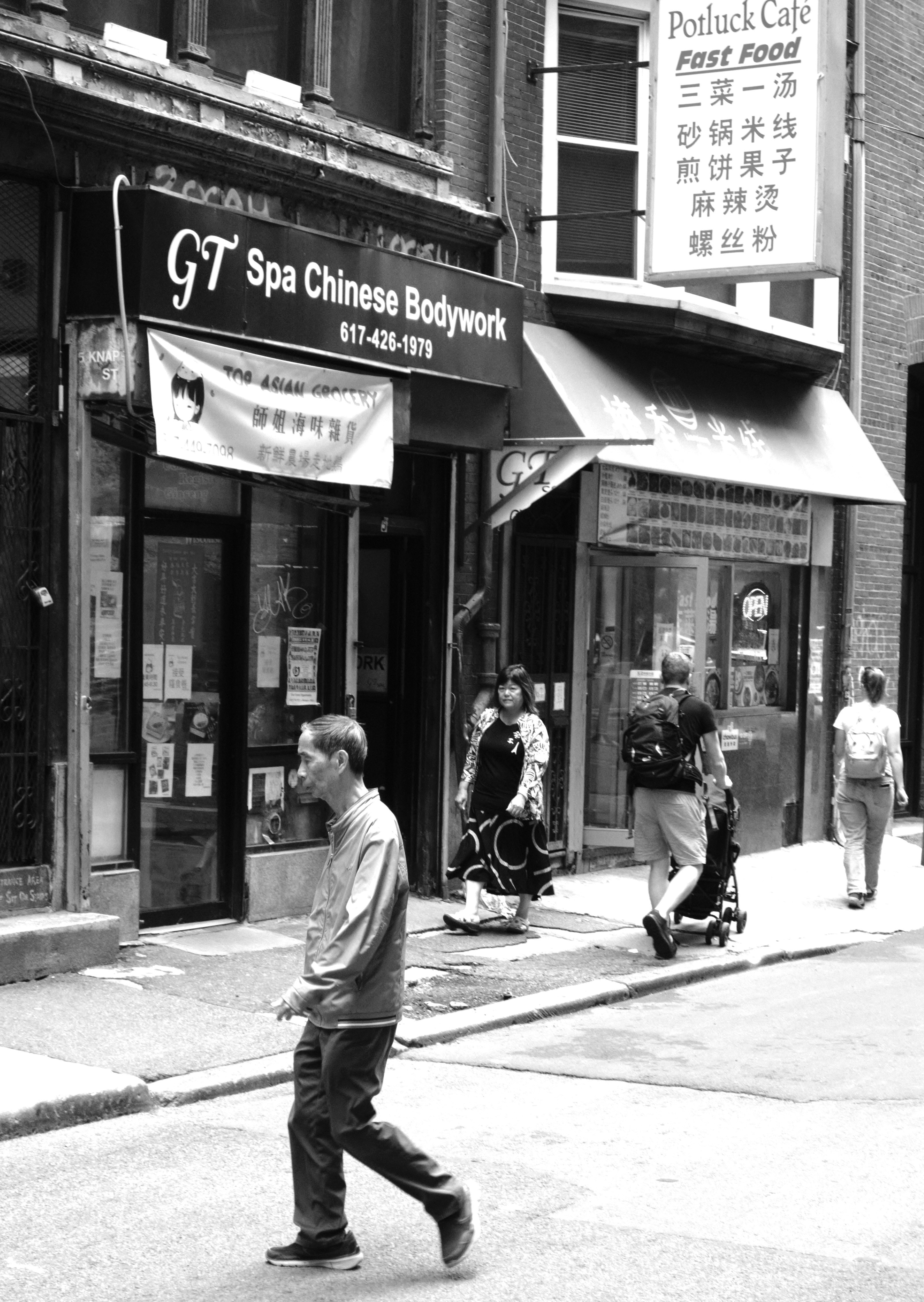 A black and white photo of a man walking down the street photo – Free ...