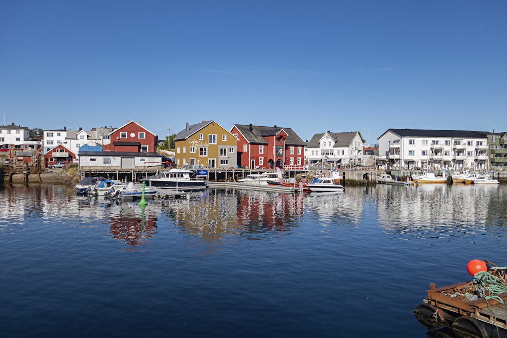 a harbor filled with lots of boats next to tall buildings