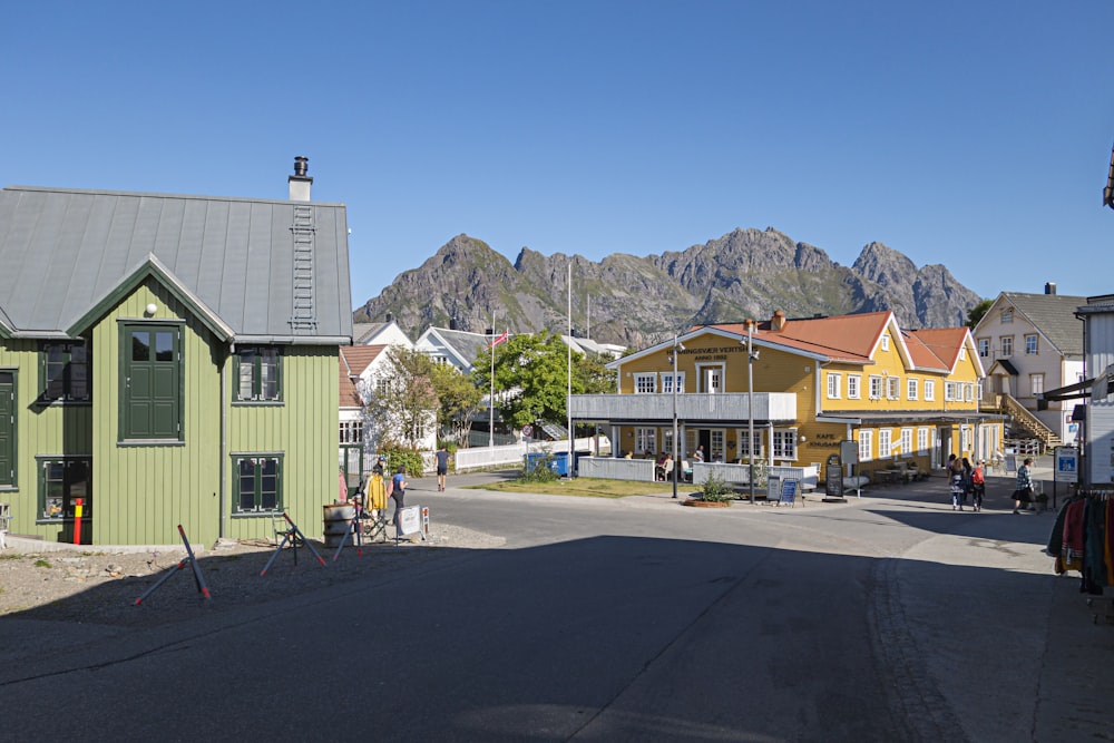 a street lined with houses with mountains in the background