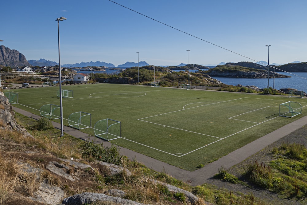 a soccer field with a view of the ocean