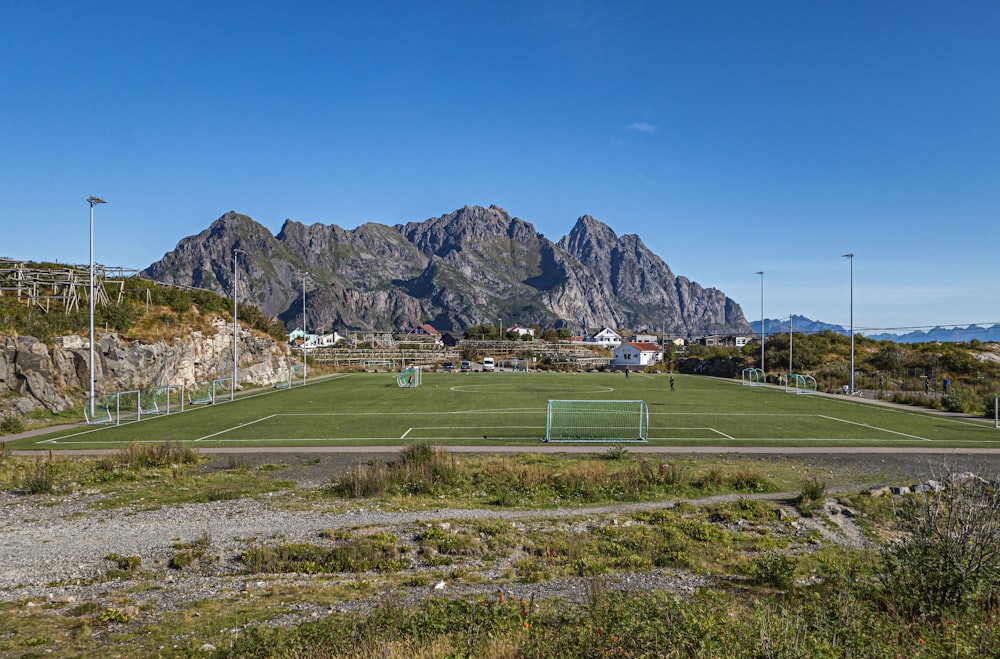 a tennis court with mountains in the background